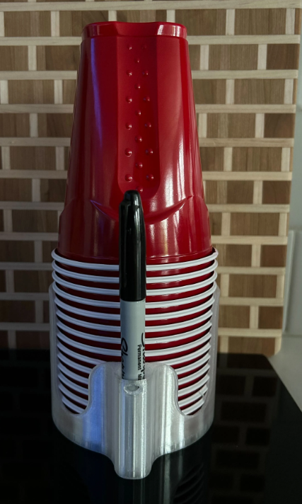 Party cup holder in Clear holding stacked red party cups and a marker