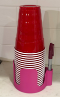 Party cup holder in Hot Pink holding stacked red party cups and a marker
